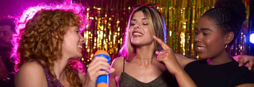 Woman singing karaoke with friends at a Doncaster party